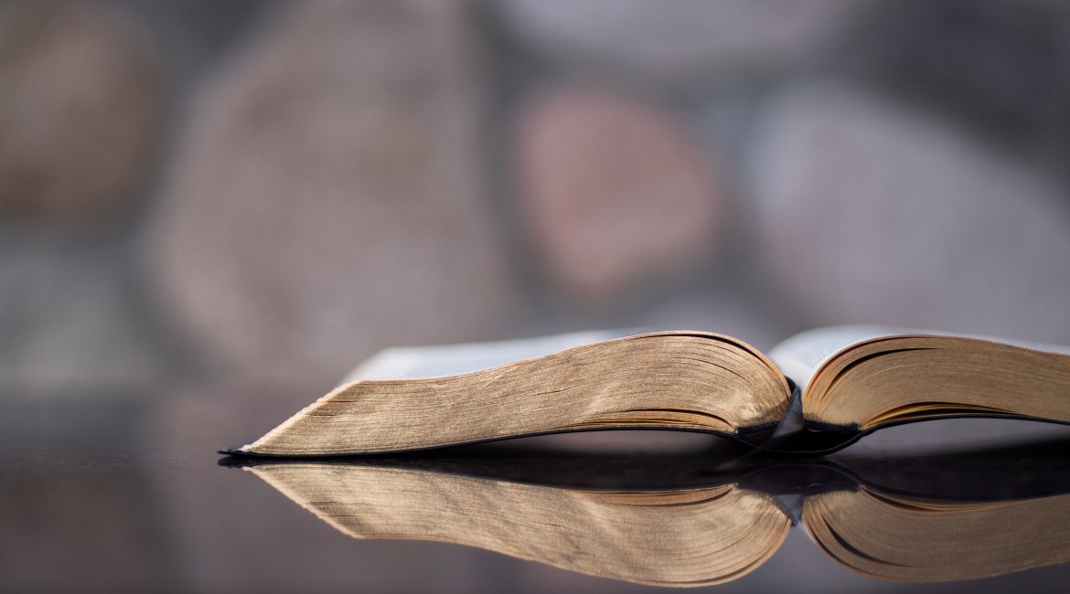 open Bible on a reflective table